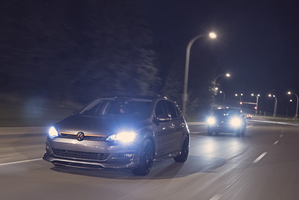 VW Golf driving under a bridge at fox drive in Edmonton at night