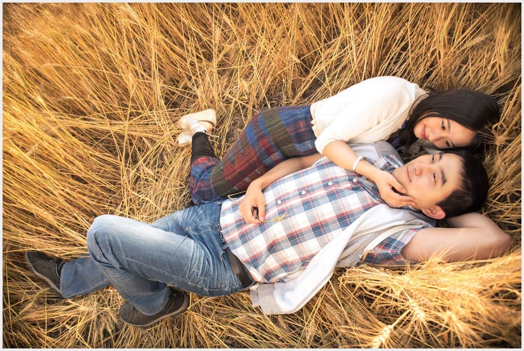 Couple laying on a field