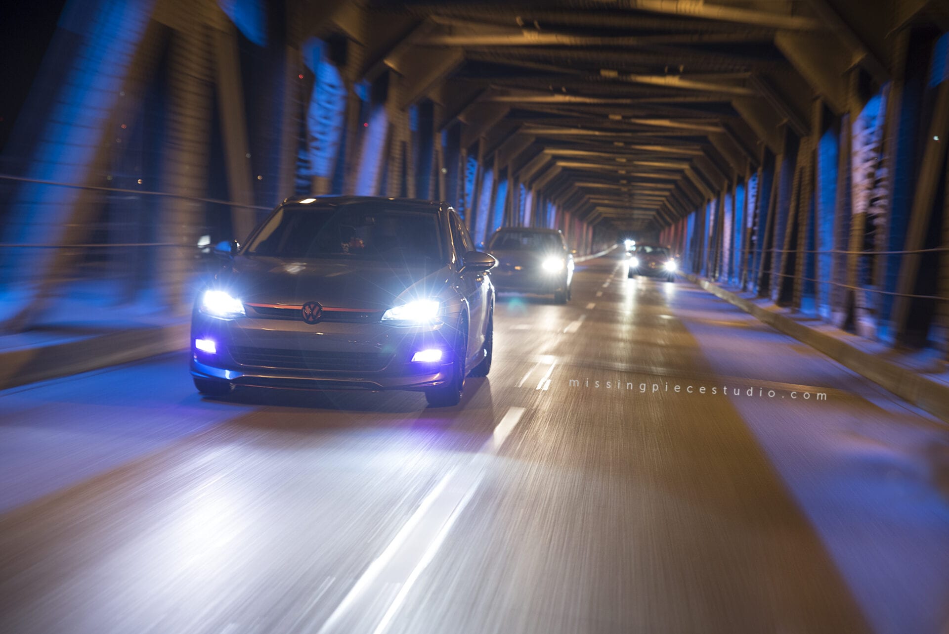 A beautiful VW golf driving down low high bridge in Edmonton