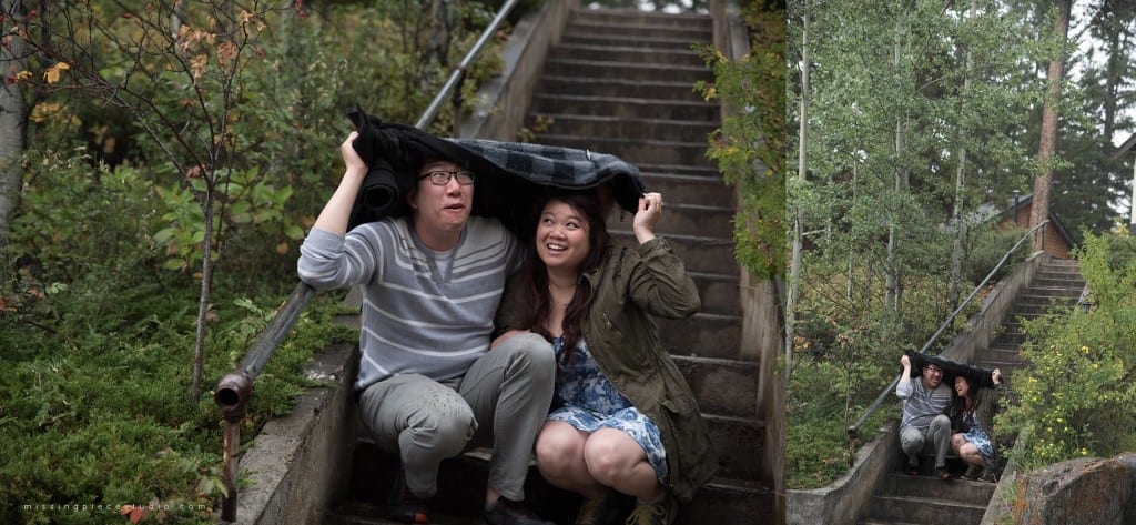 A couple hiding from the rain at a staircase in Johnston Canyon in the Banff National Park.