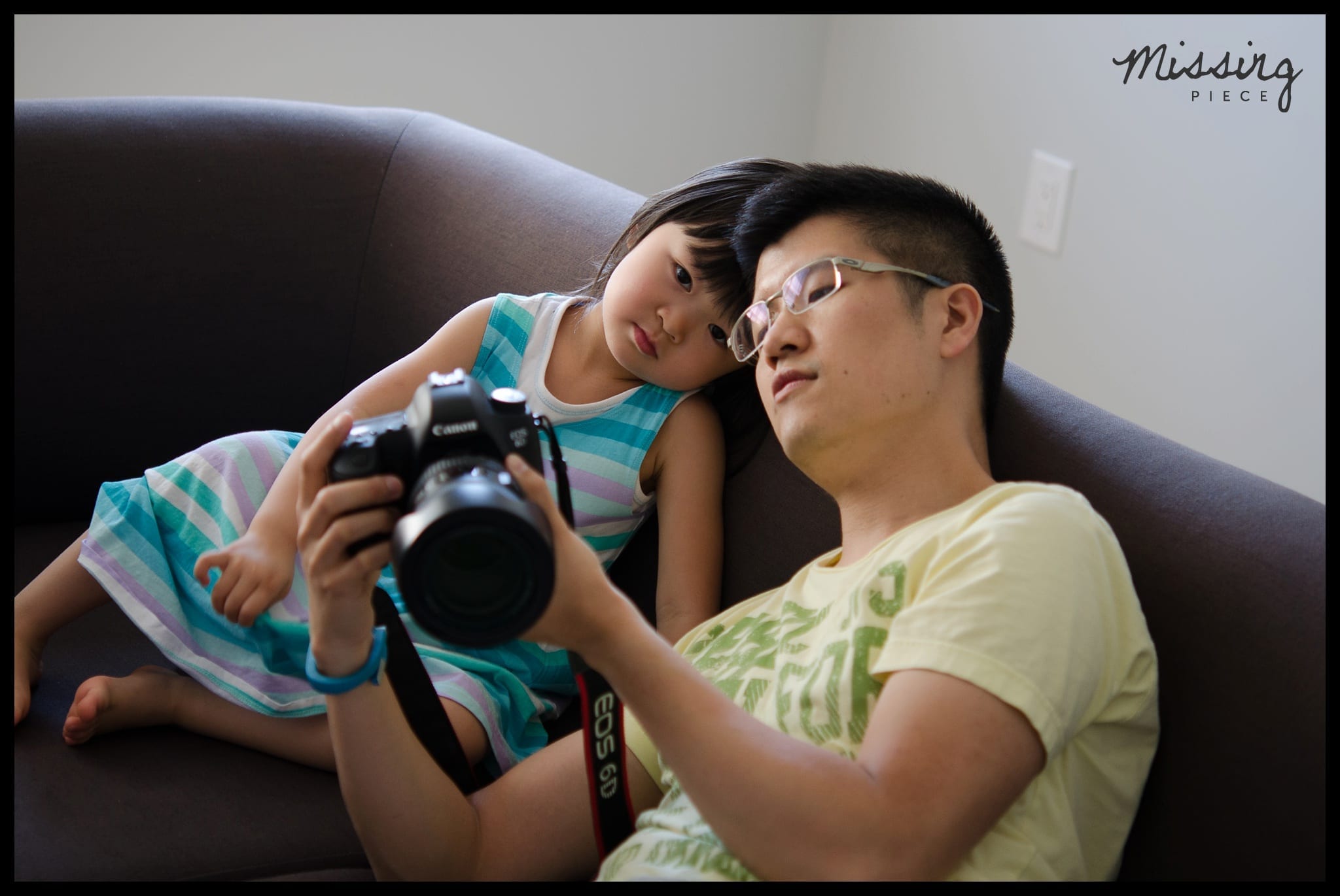 man showing him photos on his dSLR to his niece