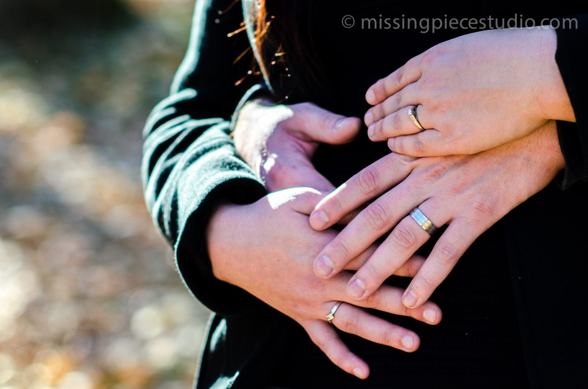 Engagement rings at the hands of a lovely couple